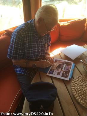 Mr.A.Barty signing a scrapbook